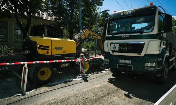 Road construction scene in Bratislava featuring heavy machinery, showcasing urban development.